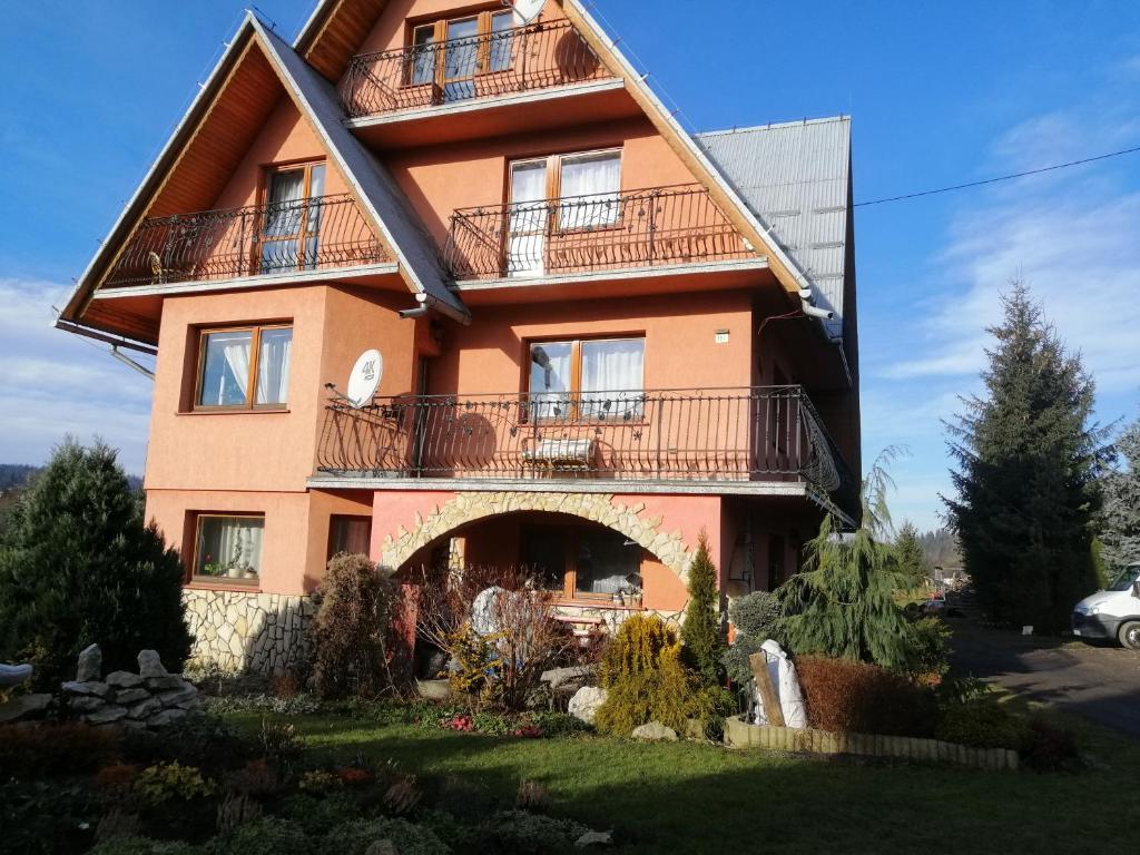 a large house with balconies on the side of it at Pokoje Ewka in Czarna Góra