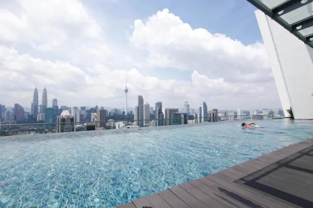 a pool on the roof of a building with a city at Regalia-Milan in Kuala Lumpur