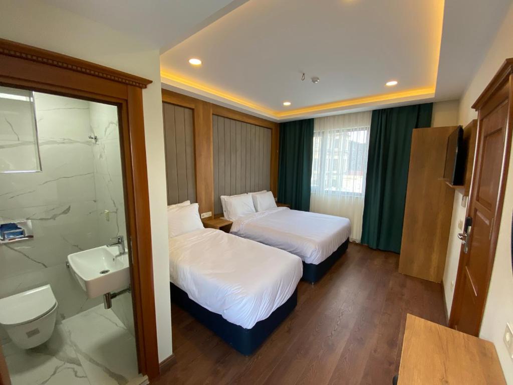 Postel nebo postele na pokoji v ubytování Pege Hotel