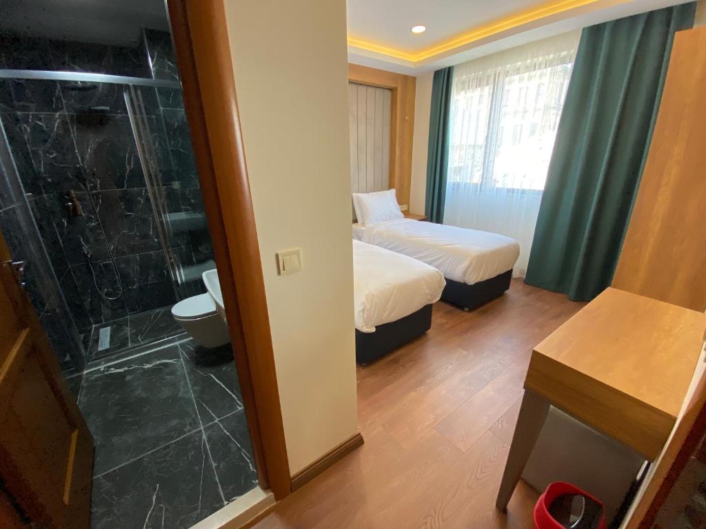 Postel nebo postele na pokoji v ubytování Pege Hotel