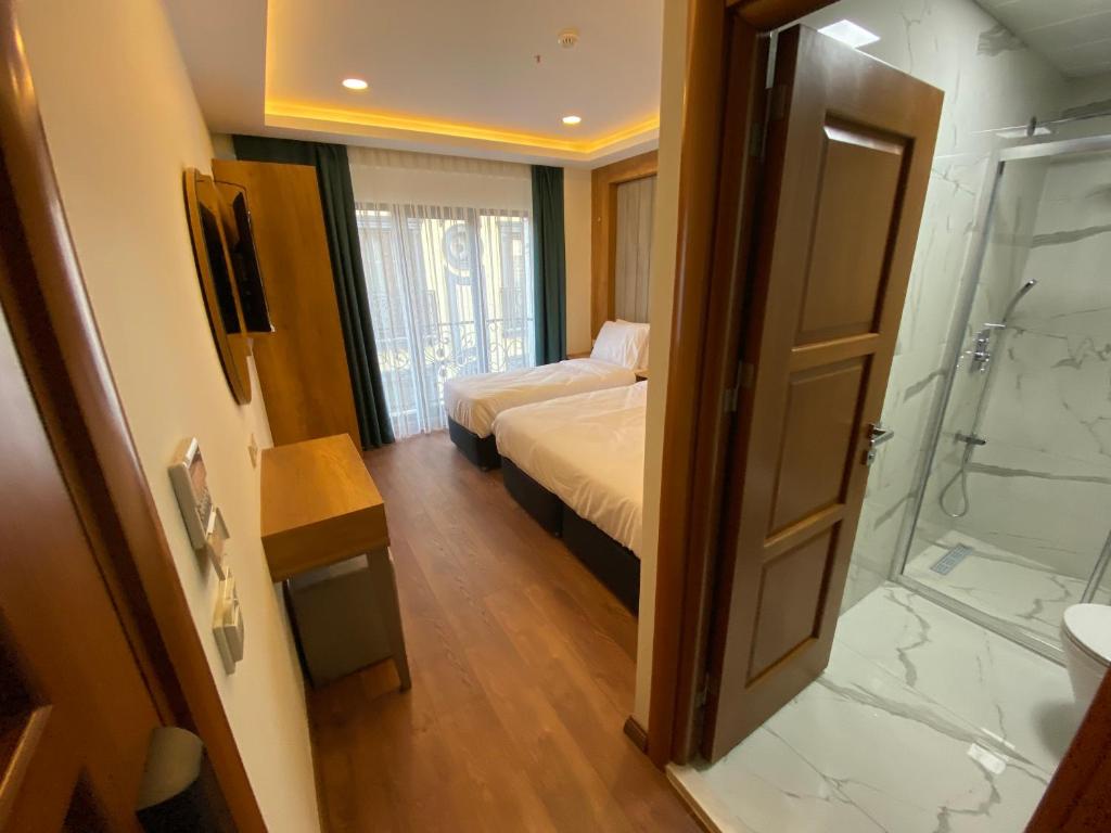 Postel nebo postele na pokoji v ubytování Pege Hotel