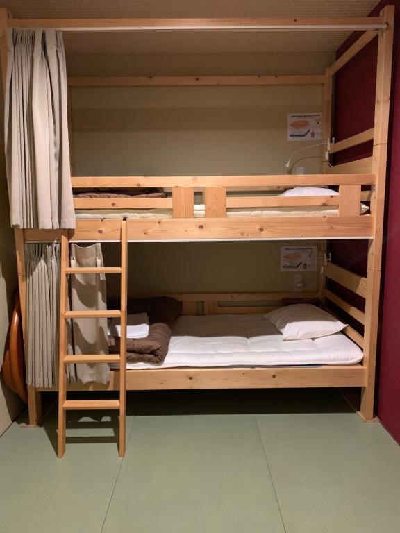 Postel nebo postele na pokoji v ubytování BEPPU ROJIURA stay&sauna
