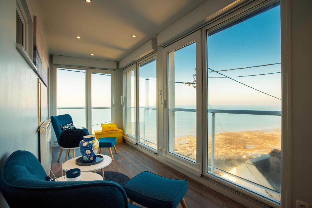 a living room with a view of the ocean at La tête Ault - Une expérience unique en bord de Mer in Ault