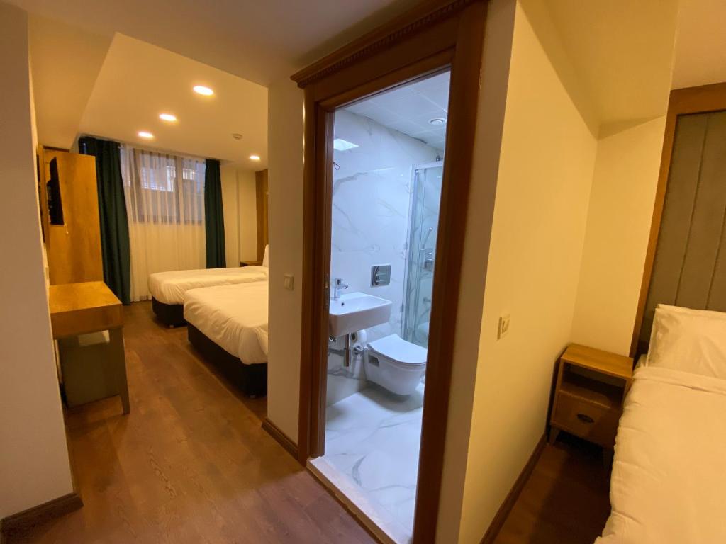 Postel nebo postele na pokoji v ubytování Pege Hotel