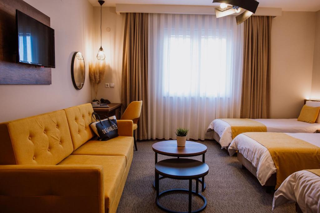 Postel nebo postele na pokoji v ubytování Hotel Kapri