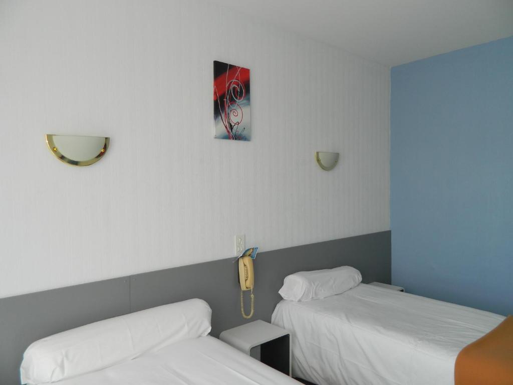 Postel nebo postele na pokoji v ubytování Logis Hôtel L'Elancèze