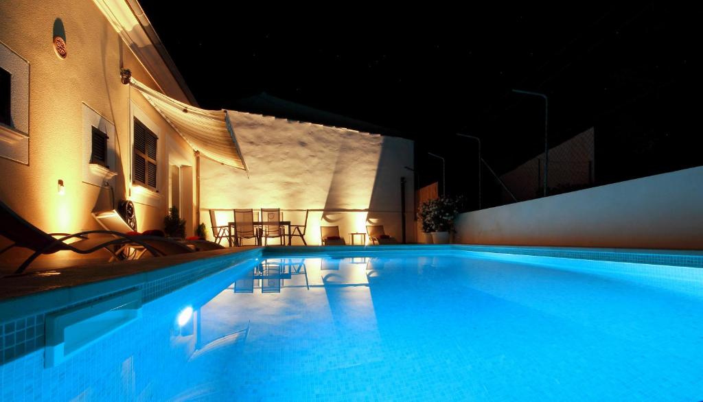 a large swimming pool at night in a building at Casa Cristòfol in Campanet