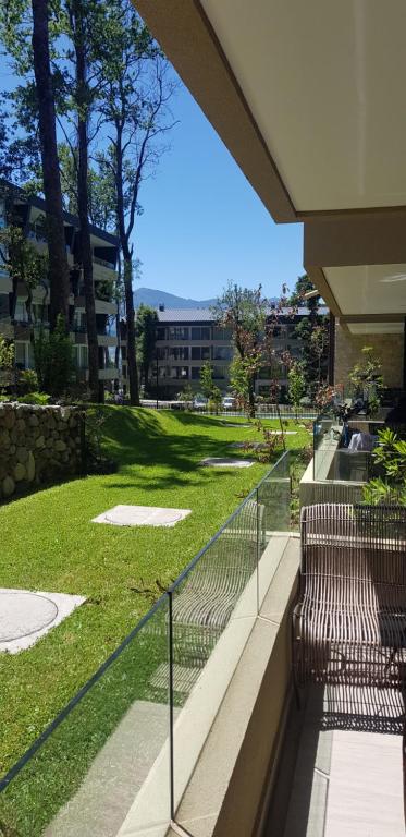 un balcone con panchine e un parco con un edificio di Departamento Pucon espectacular a Pucón