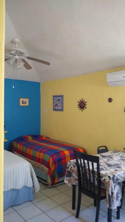 Postel nebo postele na pokoji v ubytování Coco Cabanas Loreto