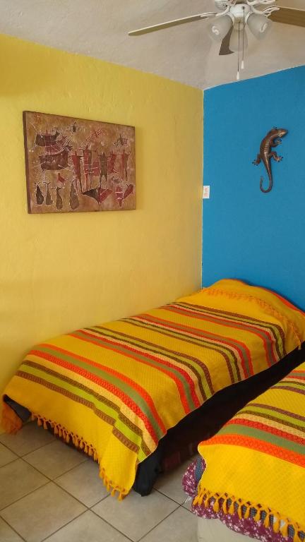 Postel nebo postele na pokoji v ubytování Coco Cabanas Loreto