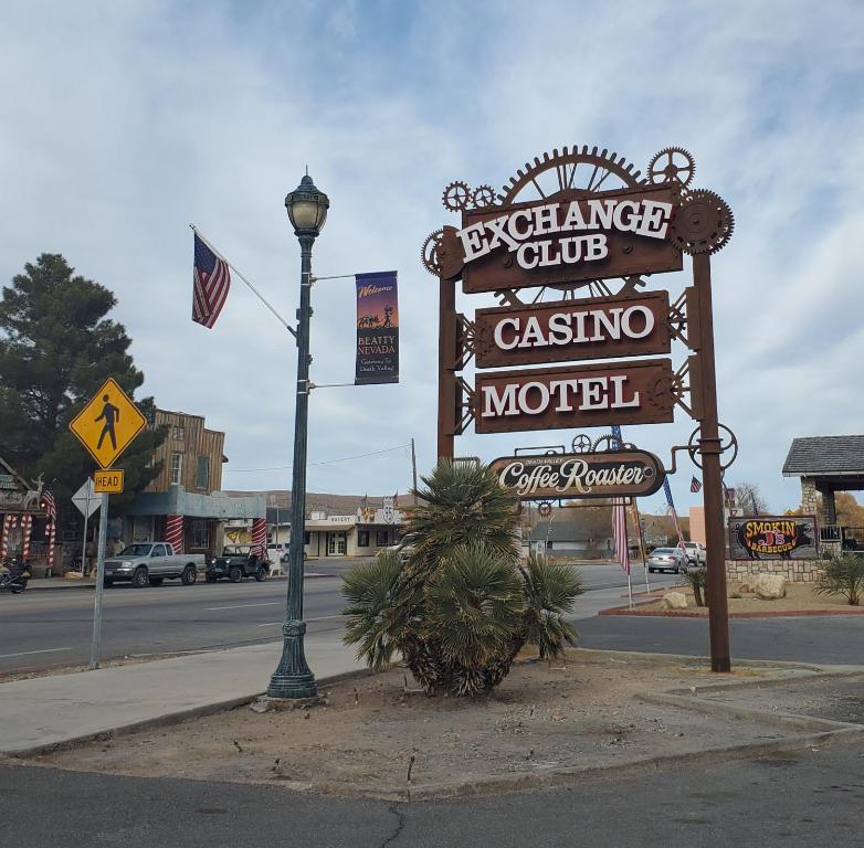 a sign for a casino motel on the side of a street at Exchange Club Motel in Beatty