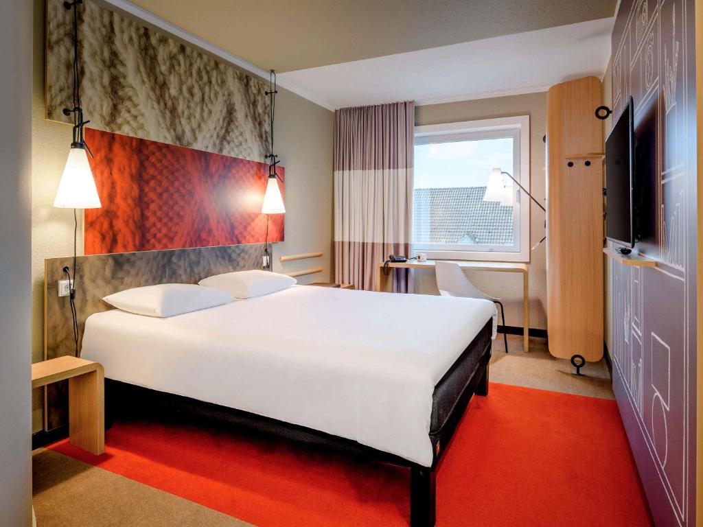 Postel nebo postele na pokoji v ubytování Ibis Münster City