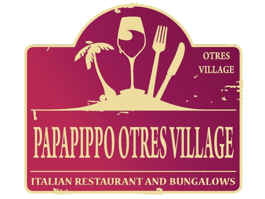 a sign for a restaurant with a glass of wine at Papa Pippo Otres Village in Sihanoukville