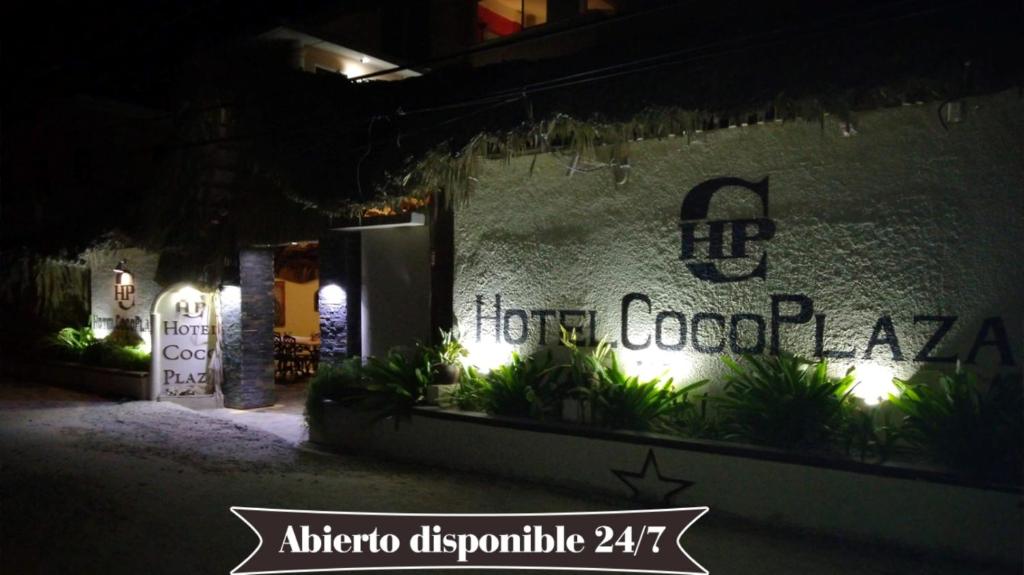 a sign on the side of a building at night at Hotel Coco Plaza in Las Terrenas