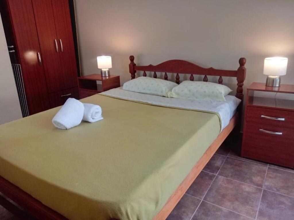 a bedroom with a large bed with two pillows on it at Cabañas La Fortaleza in La Caldera