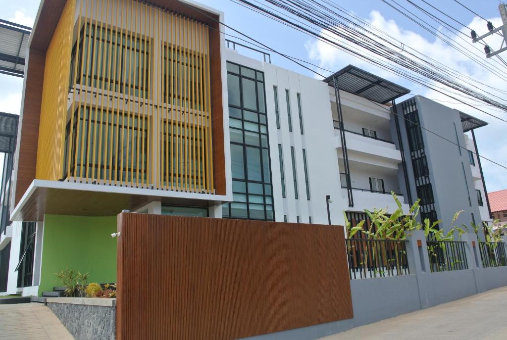 a house with a wooden fence in front of it at V.O.P Suite in Chaweng
