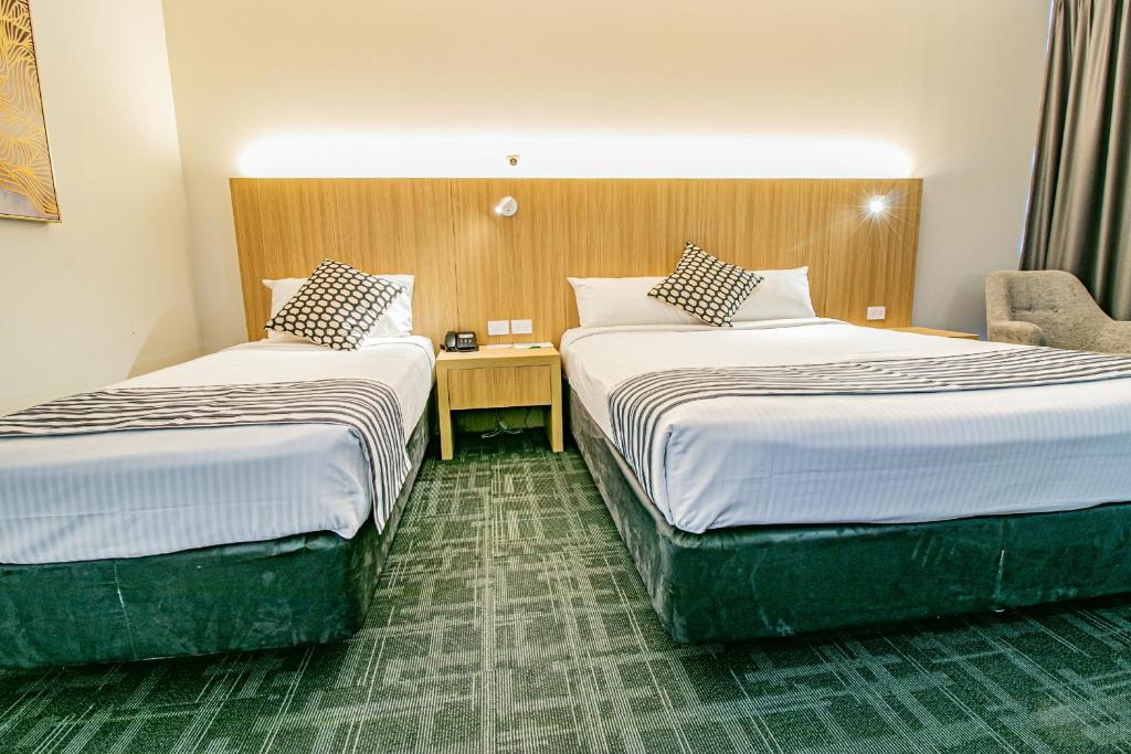 Voodi või voodid majutusasutuse Absolute Beachfront Opal Cove Resort toas