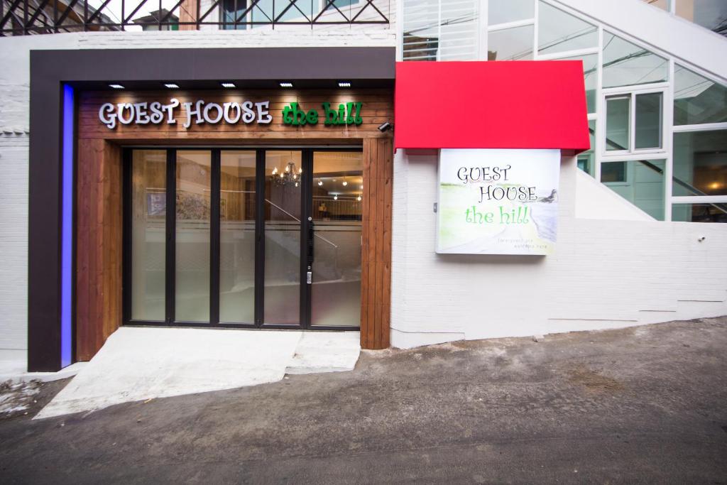 a front door of a store with a sign on it at Guesthouse The Hill in Seoul