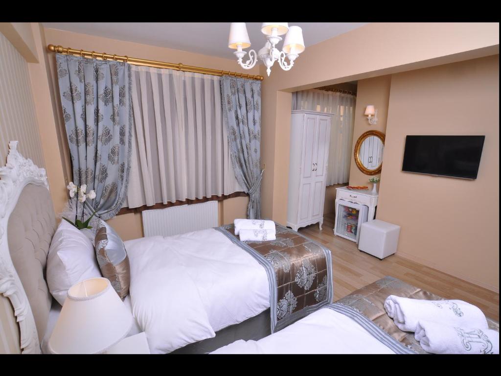 Postel nebo postele na pokoji v ubytování Divani Ali Hotel