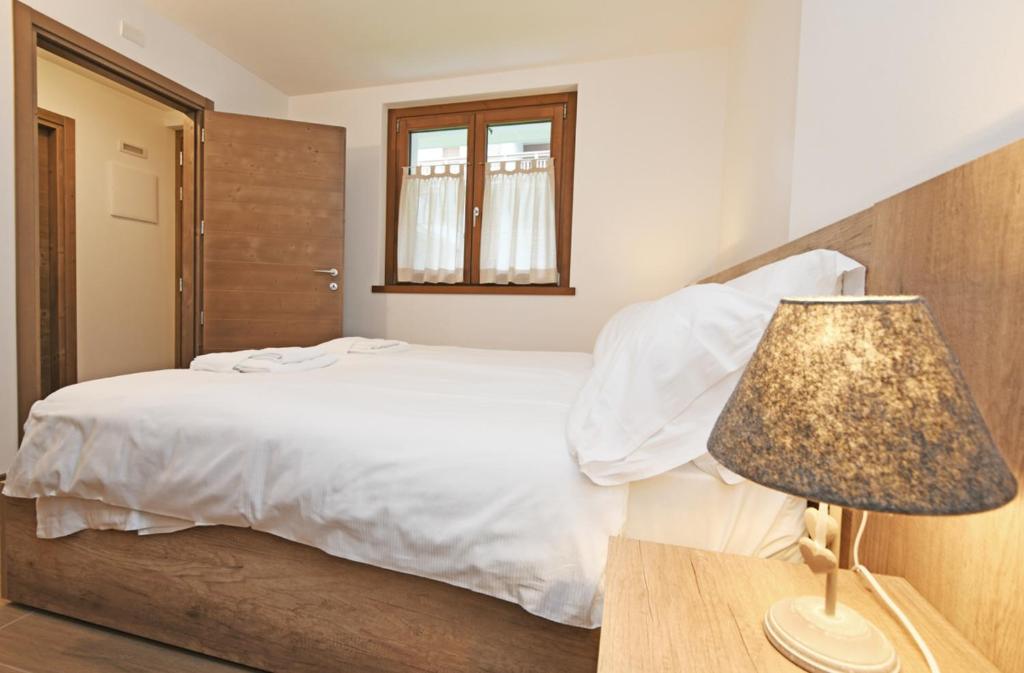 Postel nebo postele na pokoji v ubytování Ai Suma Residence