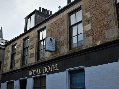 a brick building with a window on the side of it at The Royal Hotel in Stromness