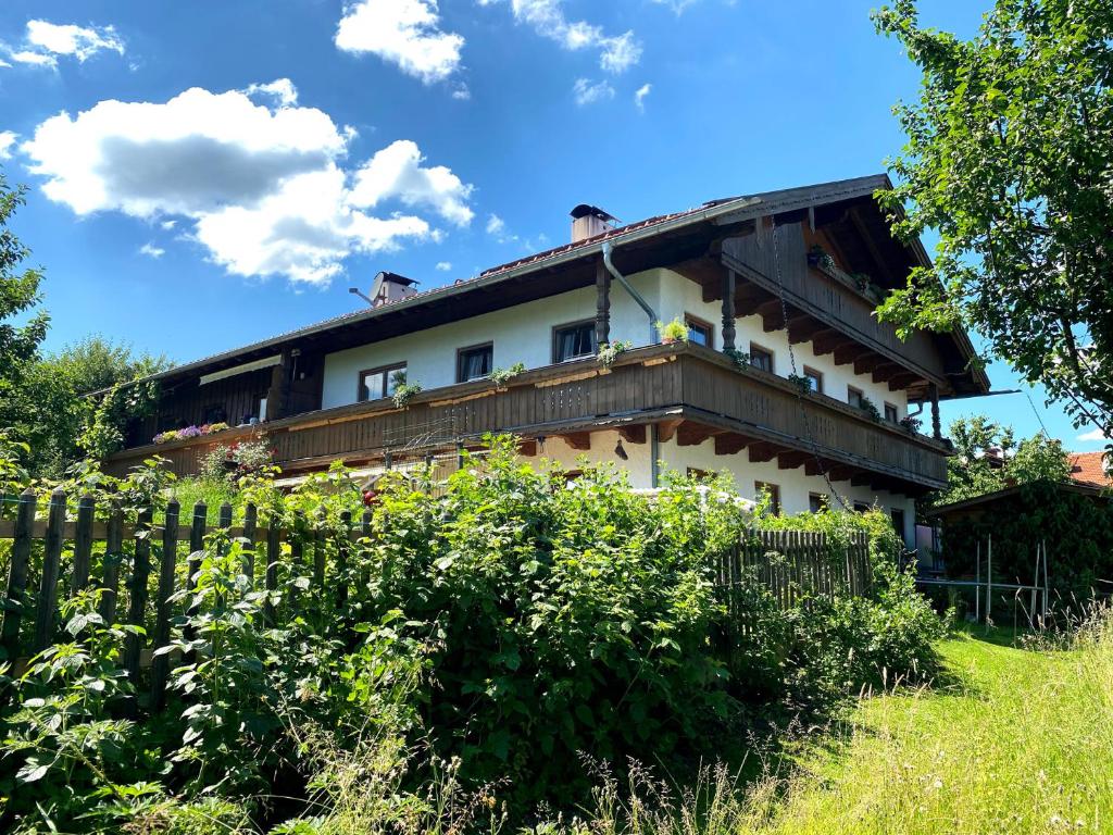 a house with a fence in front of it at Ferienwohnung Christa in Bernau am Chiemsee