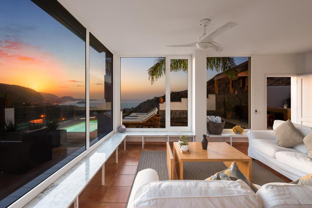 a living room with a view of the ocean at Superior A: private pool & concierge in Icod de los Vinos