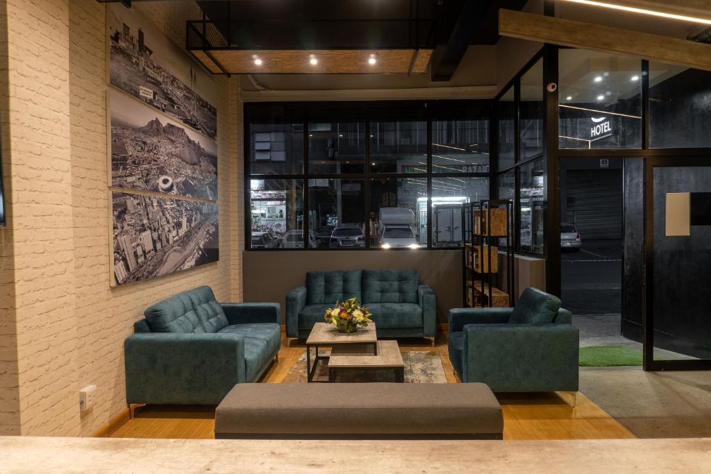 a lobby with couches and a coffee table in a building at Lilian Lofts Hotel & Spa in Johannesburg