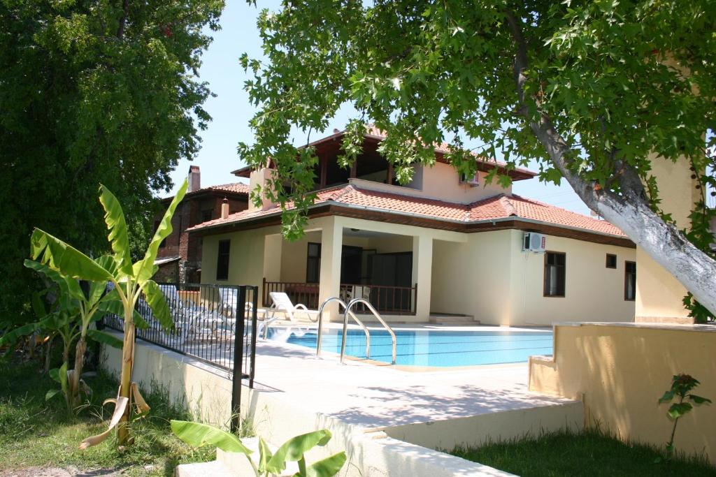 a house with a swimming pool in front of it at Begonville Villa in Koycegiz