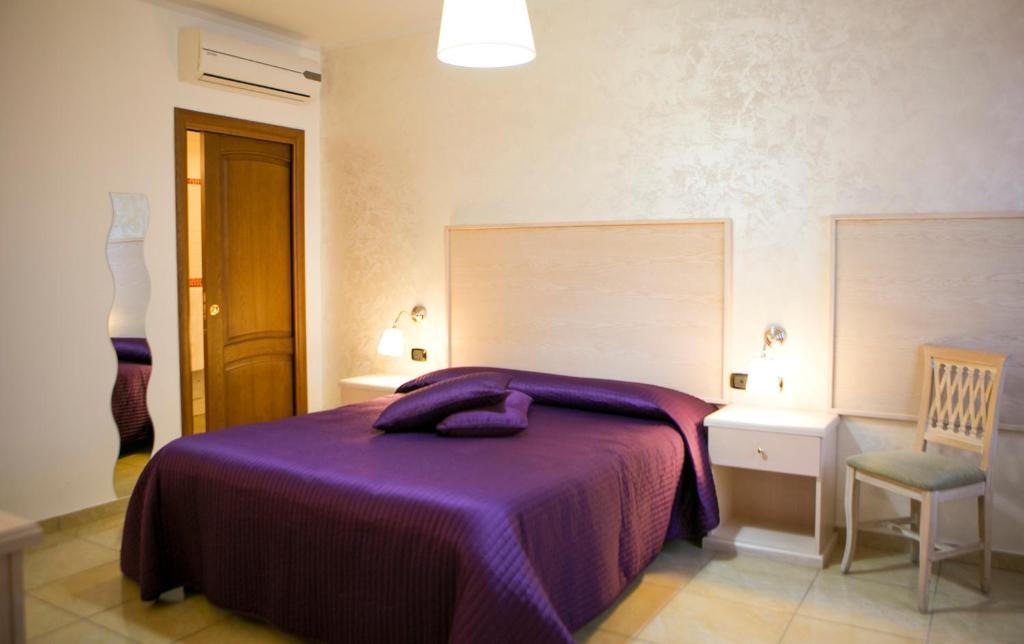 Postel nebo postele na pokoji v ubytování Hotel Miramare