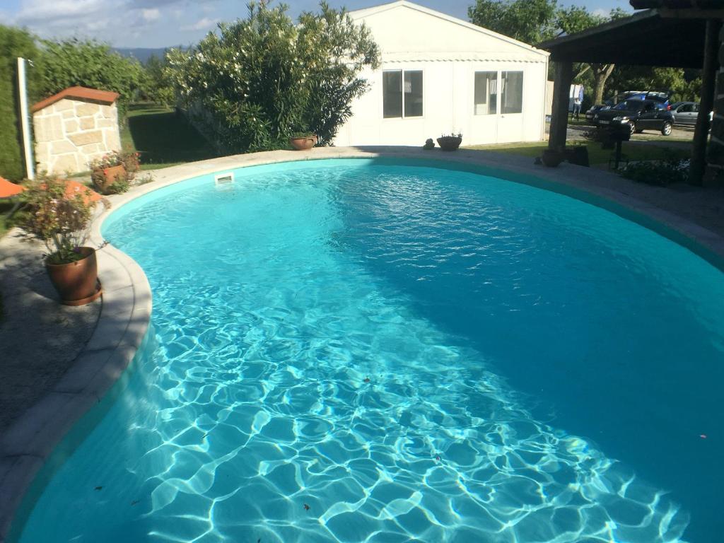 a swimming pool with blue water in a yard at Welcoming villa near Penafiel with pool in Abol de Cima