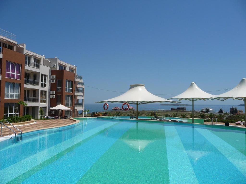 una gran piscina con sombrillas en la parte superior de un edificio en Great Choice Apartment, en Chernomorets