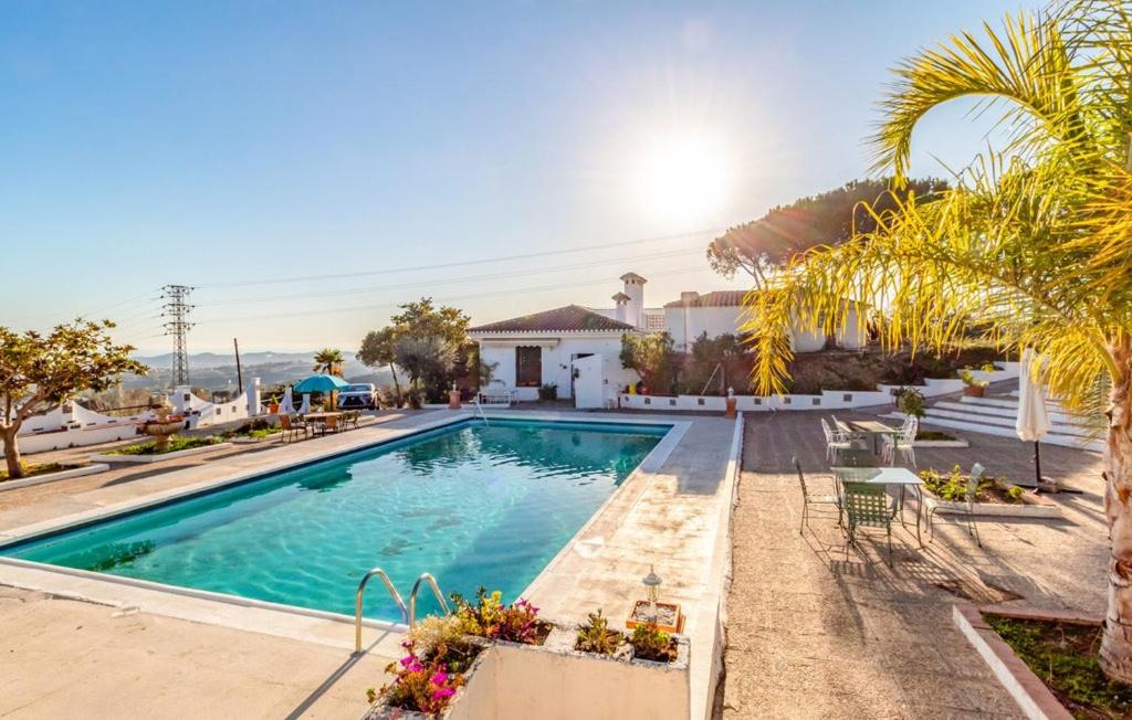 a swimming pool in a villa with a palm tree at Exceptional villa in Mijas with private pool, sea view in Mijas