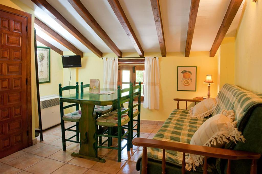 a living room with a table and a couch at Comfortable Apartment in Robledillo de Gata with Balcony and View in Robledillo de Gata