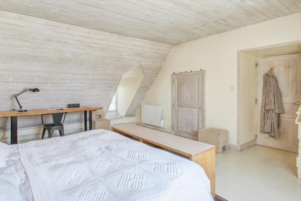 a bedroom with a bed and a desk and a table at Maison de 3 chambres avec vue sur la mer jardin clos et wifi a Regneville sur Mer a 2 km de la plage in Regnéville-sur-Mer