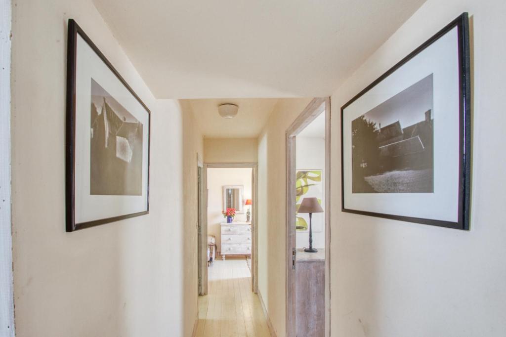 a hallway with three framed pictures on the wall at Maison de 3 chambres avec vue sur la mer jardin clos et wifi a Regneville sur Mer a 2 km de la plage in Regnéville-sur-Mer