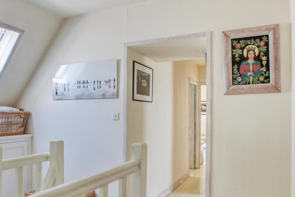 a staircase in a house with a painting on the wall at Maison de 3 chambres avec vue sur la mer jardin clos et wifi a Regneville sur Mer a 2 km de la plage in Regnéville-sur-Mer