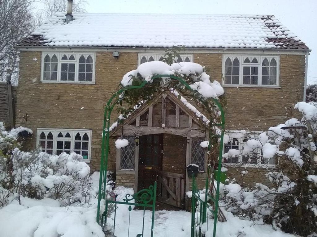 a house with snow on top of it at Remarkable 3 Bed Cottage in Bath in Woolverton