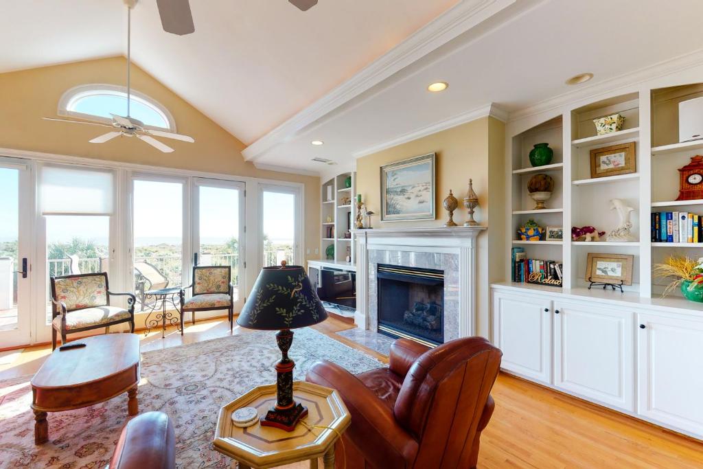 a living room with a couch and a fireplace at Catesby's Bluff 2240 in Seabrook Island