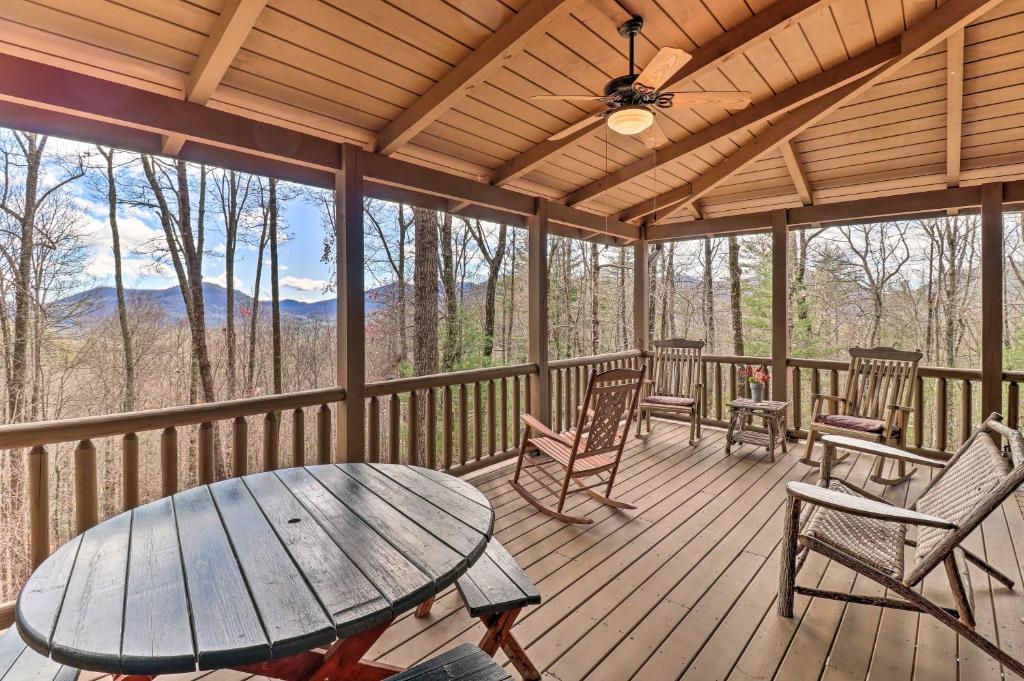 a screened in porch with a table and chairs at Private Sapphire Valley Resort Cabin with MTN Views! in Sapphire