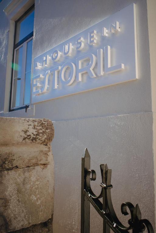 a sign on the side of a building with a window at A House in Estoril - Adults Only in Estoril