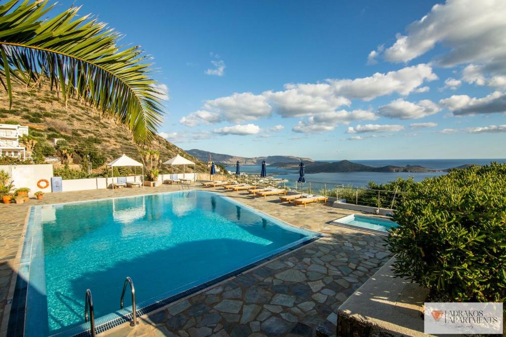 a swimming pool with a view of the water at Adrakos Apartments (Adults Only) in Elounda