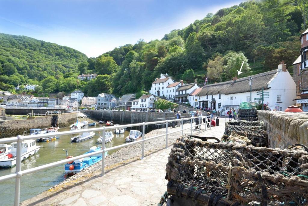 a small town with boats in the water at Superb Sea View Apartment in Lynmouth