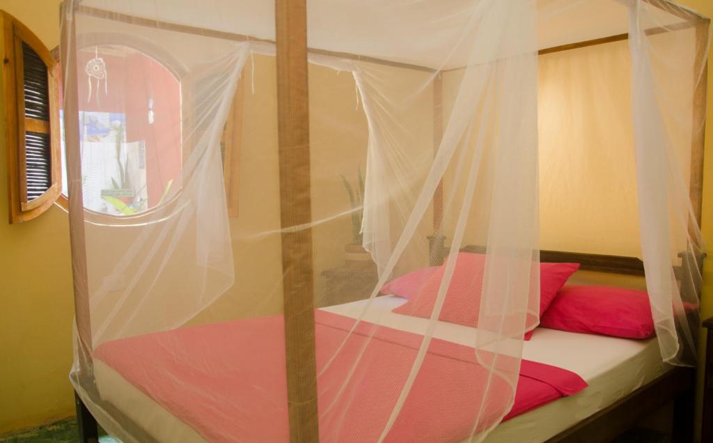 Ένα ή περισσότερα κρεβάτια σε δωμάτιο στο Hostal Corazón de Tagua