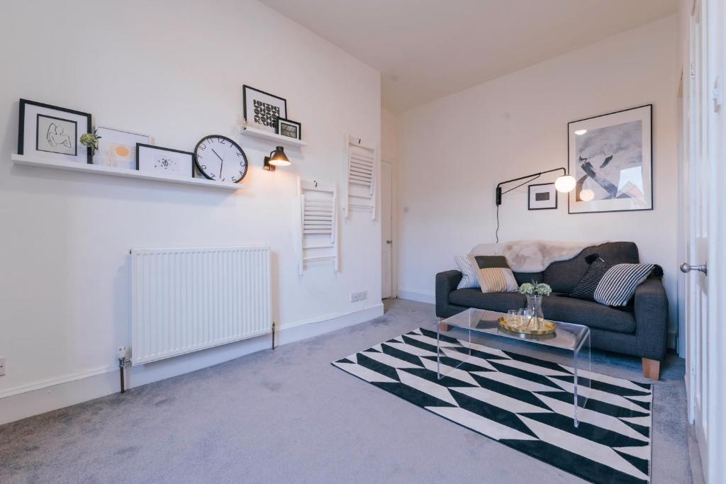 een woonkamer met een bank en een tafel bij Stylish and Comfortable City Centre Apartment in Edinburgh