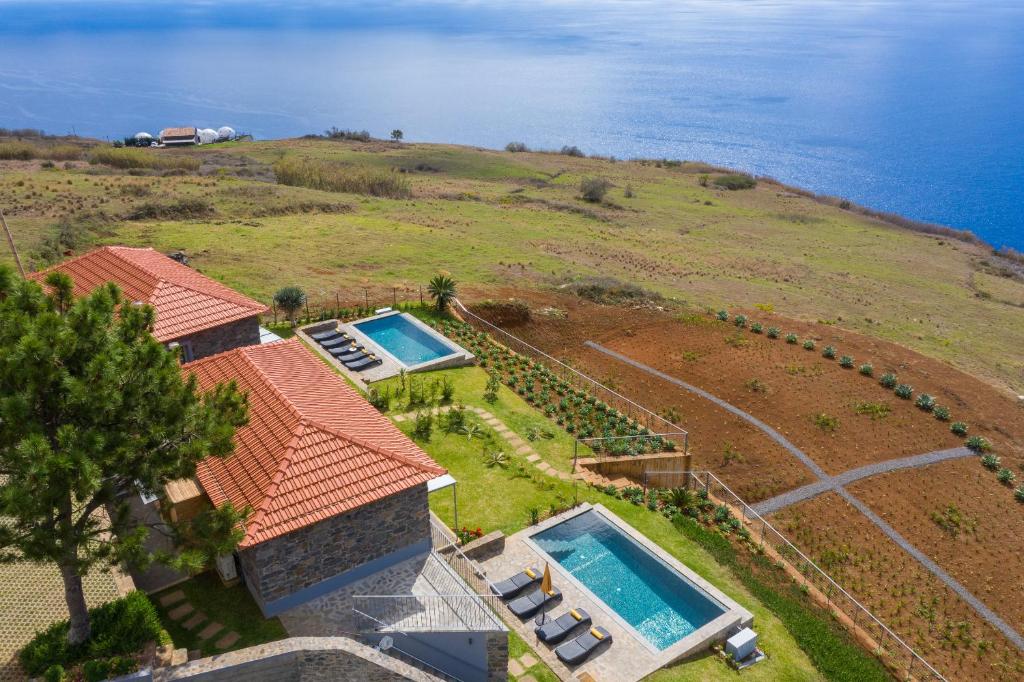 an aerial view of a house with two swimming pools at Cantinho da Natureza - Nature & Tranquility - Heated pool optional in Jardim do Mar