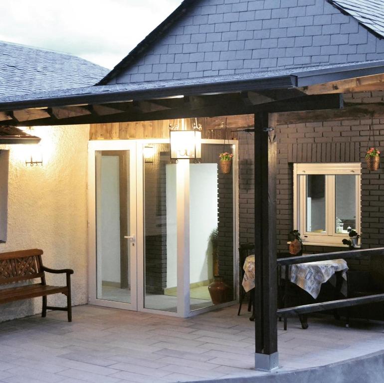 a pavilion with glass doors on a patio at O Prado do Forno in O Barco de Valdeorras