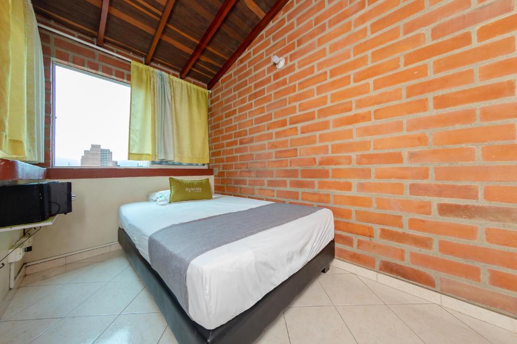 Postel nebo postele na pokoji v ubytování Ayenda 1231 Paradise Center