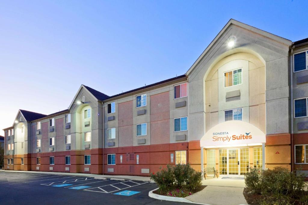 an image of an apartment building with a parking lot at Sonesta Simply Suites Philadelphia Mount Laurel in Mount Laurel
