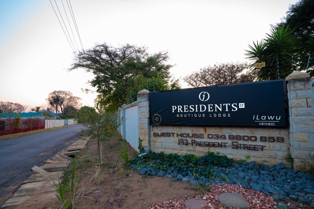 a sign for the presidents furniture house on the side of a road at Presidents Boutique Lodge by Ilawu in Vryheid